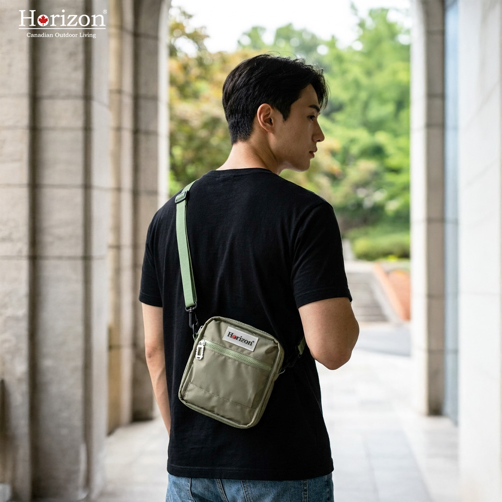 Green Horizon Toastie Crossbody Bag worn as a gender-neutral compact daily carry style