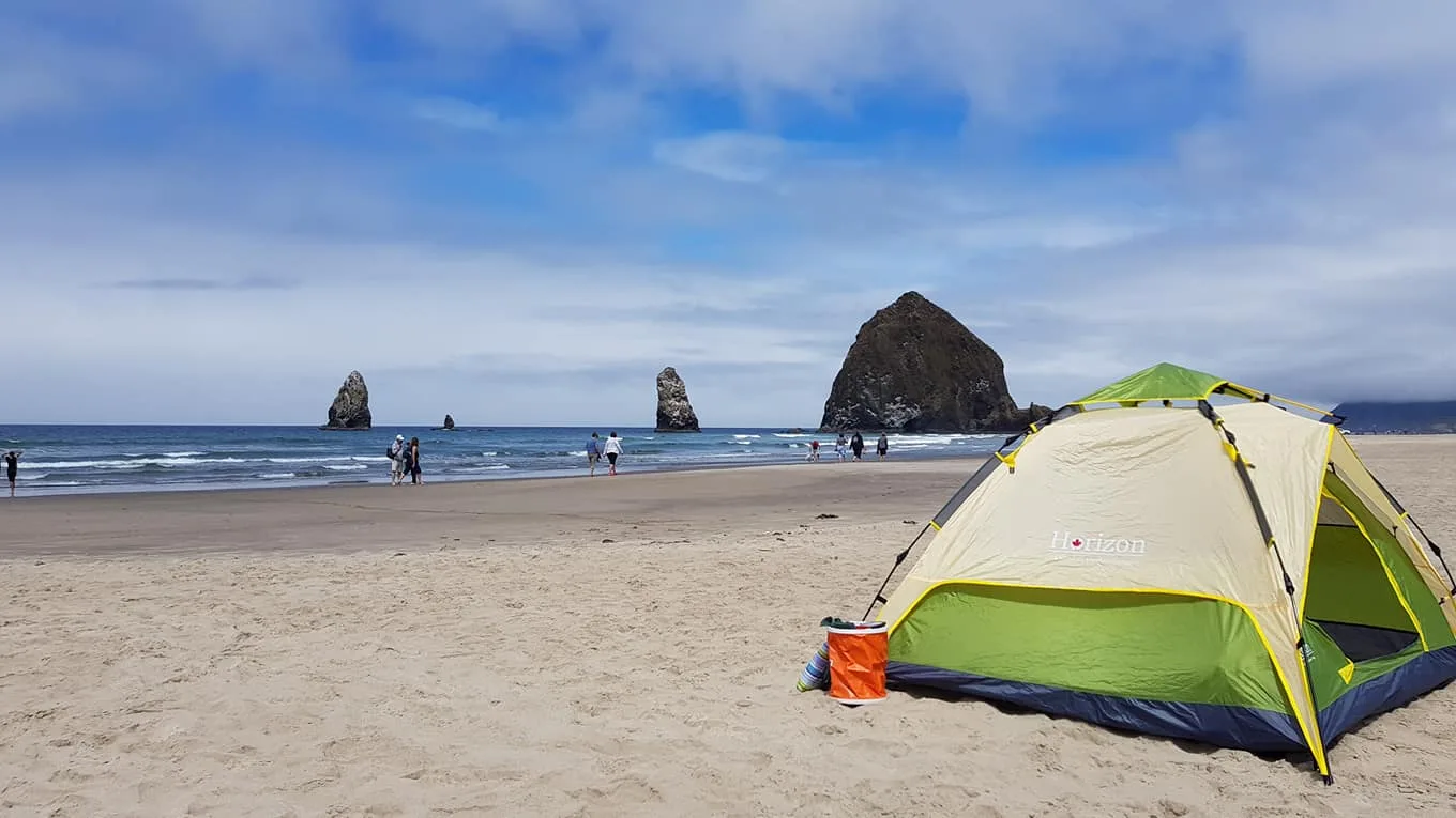 Horizon tent set up on a sandy beach near the ocean